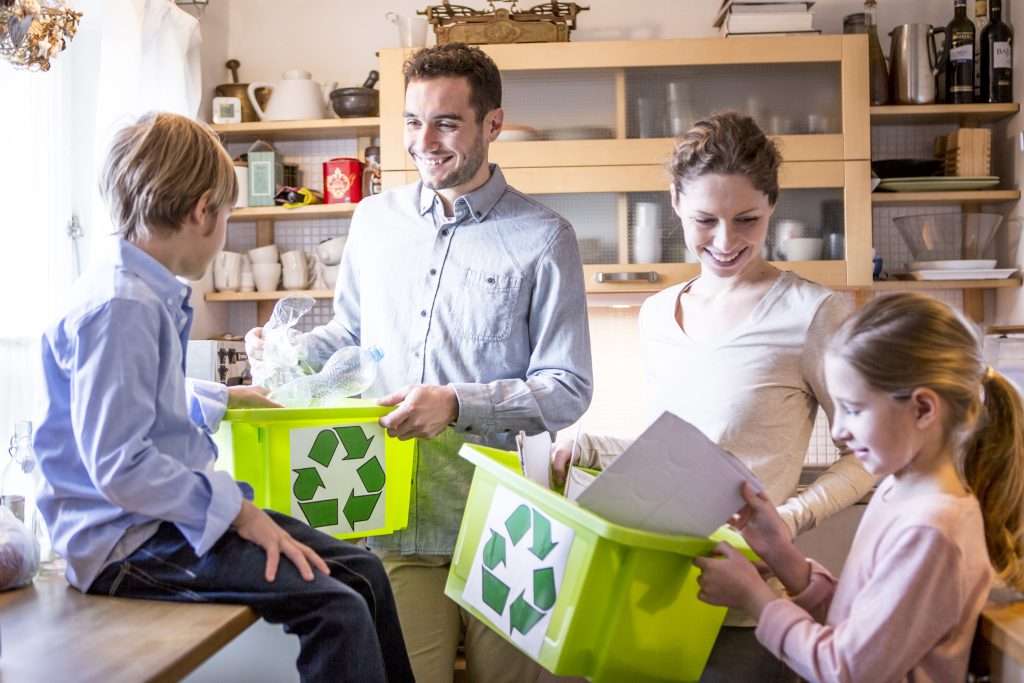 Junge Familie in der Küche mit Trennboxen für verschiedene Abfälle, Foto: Envato Elements